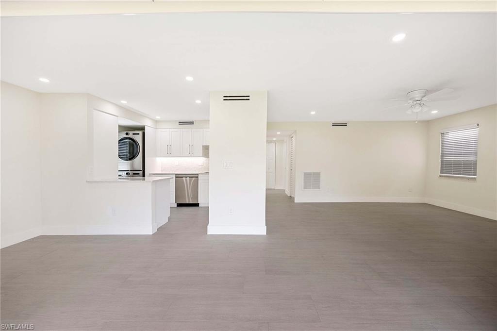 1155 Sandpiper Street, Unit F7 Naples, FL 34102 - Photo 9 of 29 a view of a big room with kitchen and windows