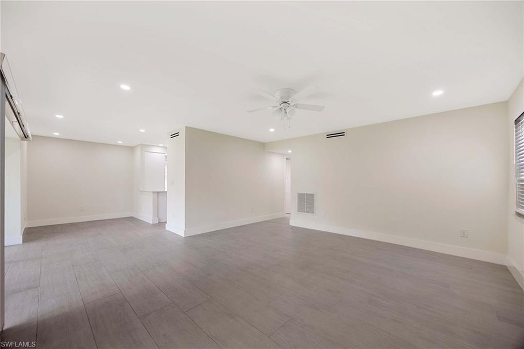 1155 Sandpiper Street, Unit F7 Naples, FL 34102 - Photo 10 of 29 an empty room with a ceiling fan and a window