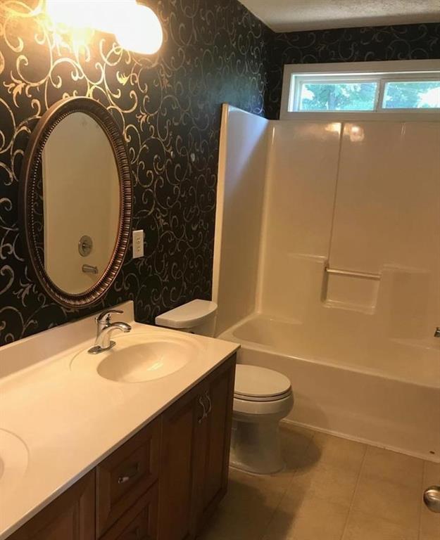 436 Abbey Place Villa Rica, GA 30180 - Photo 12 of 12 a bathroom with a sink mirror vanity and toilet