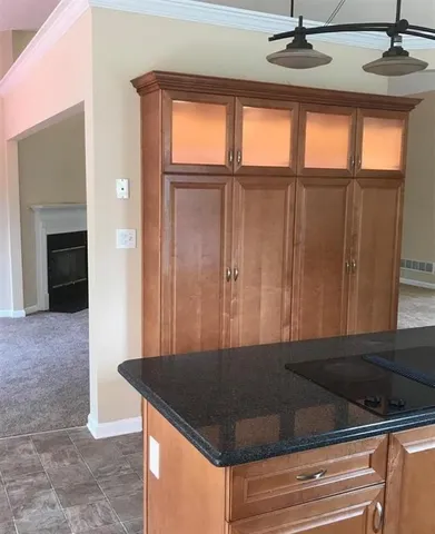 a view of a livingroom with a kitchen and a window