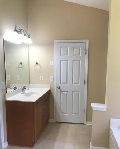 a bathroom with a double vanity sink and a mirror
