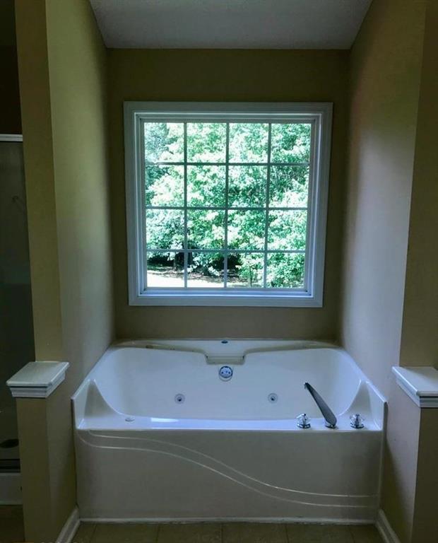 436 Abbey Place Villa Rica, GA 30180 - Photo 9 of 12 a bathroom with a bathtub and window