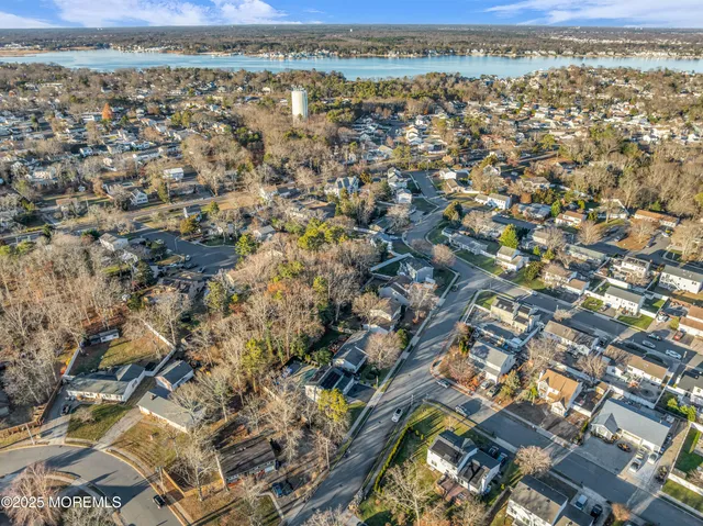 an aerial view of a residential houses with yard