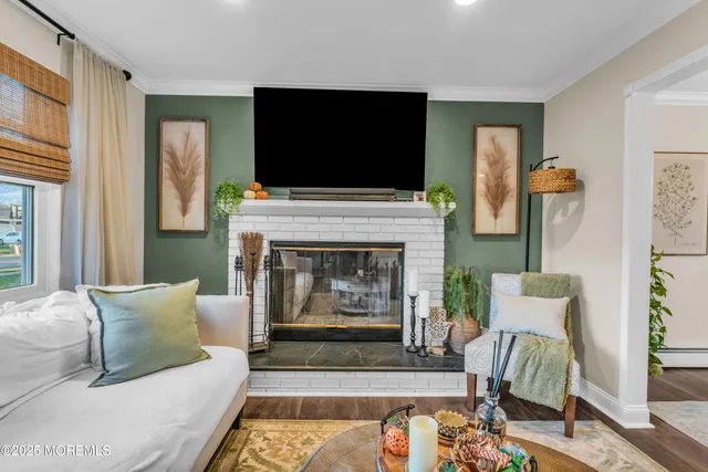 a living room with furniture a flat screen tv and a fireplace