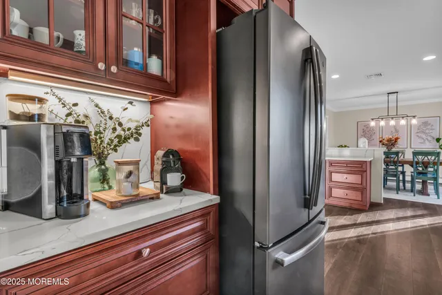 a kitchen with refrigerator and table