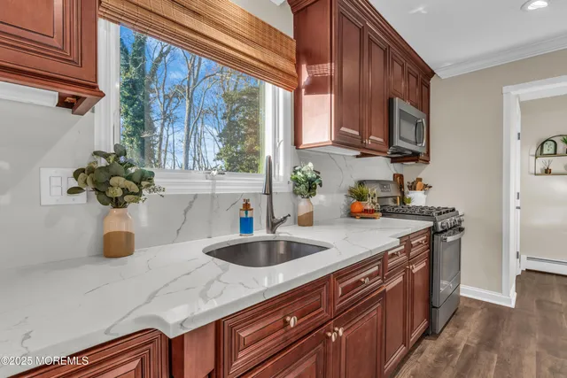 a kitchen with sink a window and cabinets