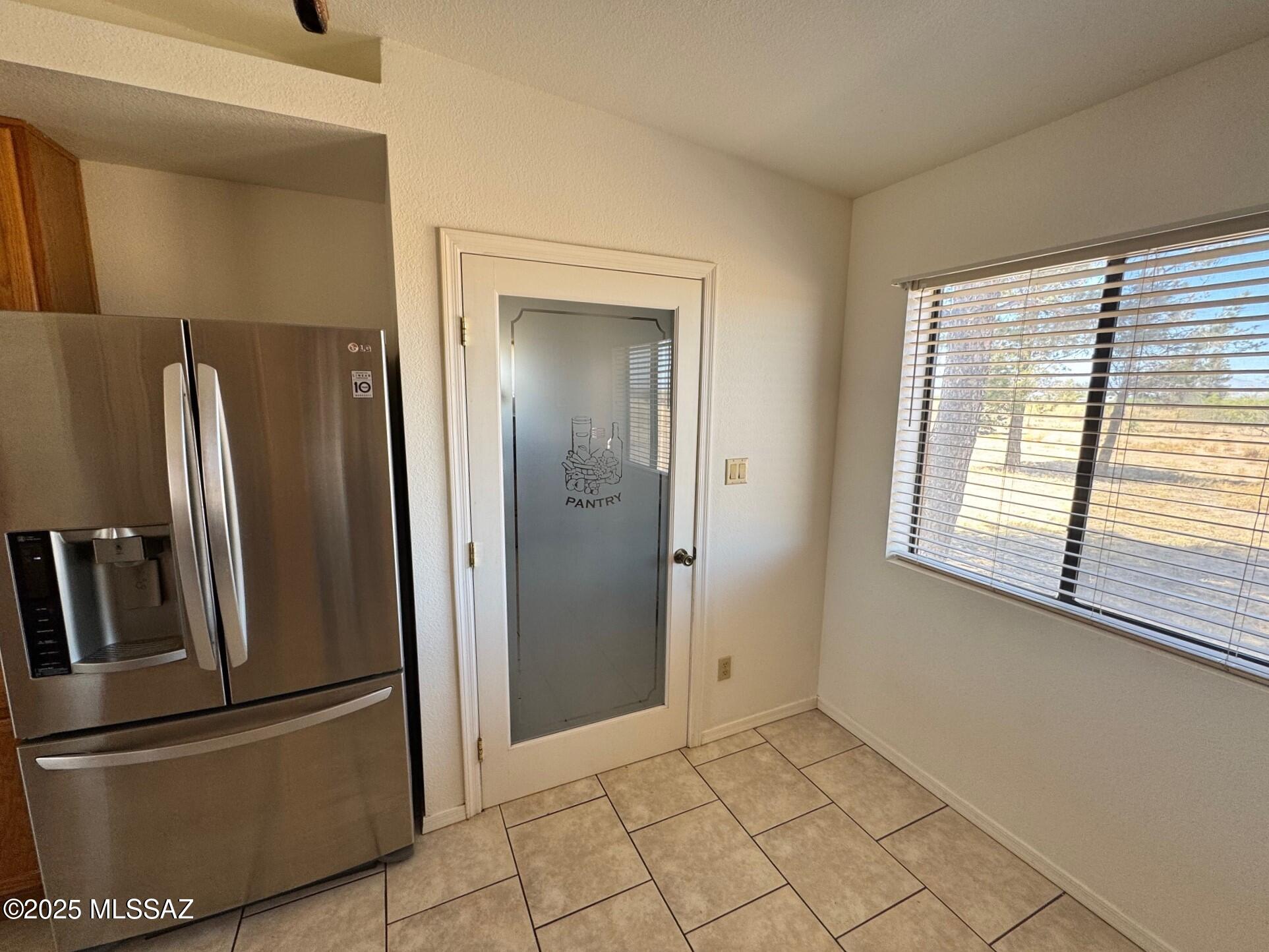 13384 South Cottonwood Road Pearce, AZ 85625 - Photo 13 of 46 a view of a refrigerator in kitchen and an empty room
