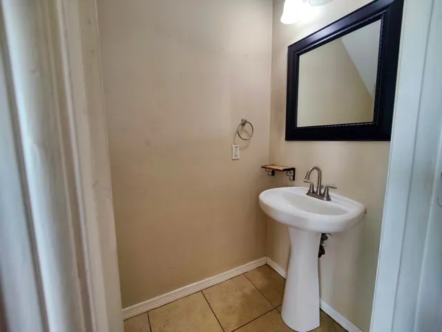 a bathroom with a sink mirror and toilet