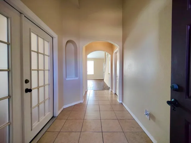a view of a hallway with wooden shelves
