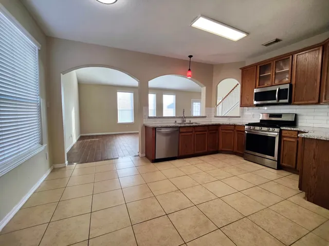 a kitchen with stainless steel appliances granite countertop a stove and a sink