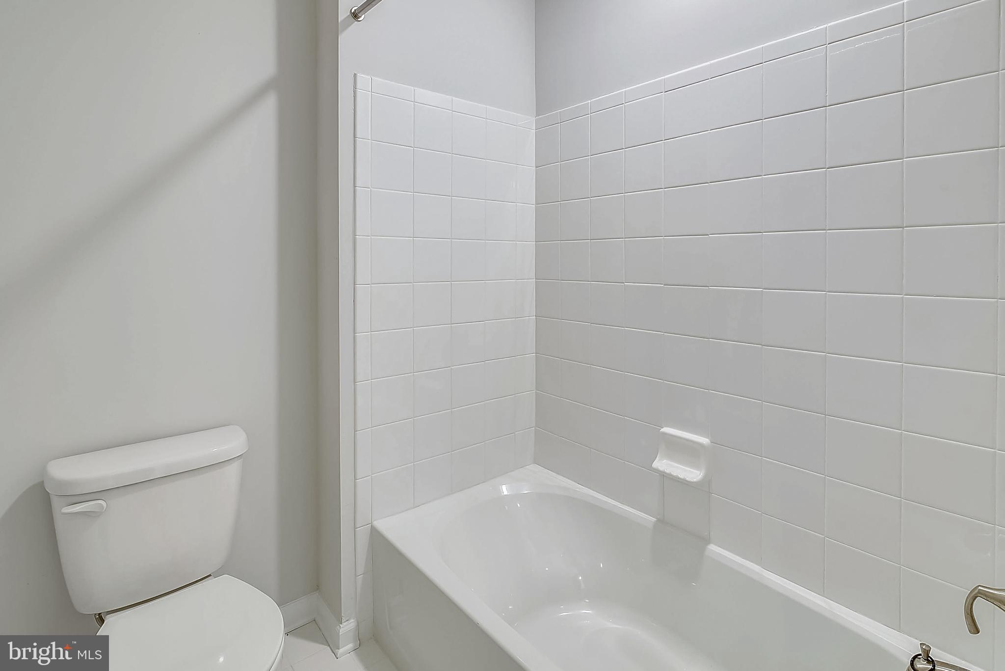 13814 Pecan Ridge Way Bowie, MD 20715 - Photo 8 of 14 a bathroom with a toilet and bathtub