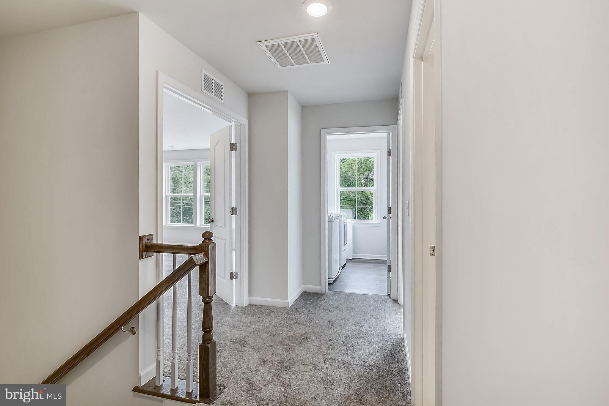 13814 Pecan Ridge Way Bowie, MD 20715 - Photo 9 of 14 a view of a hallway with wooden floor and stairs