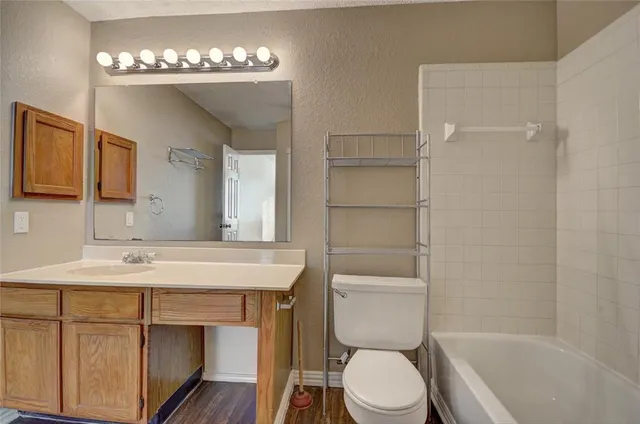 a bathroom with a sink toilet a mirror and shower