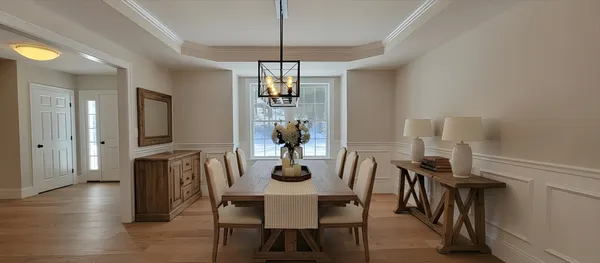 a dining room with furniture window and wooden floor