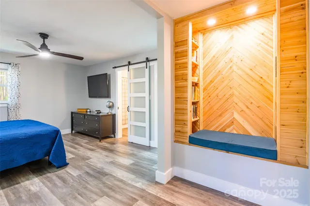a bedroom with furniture and flat screen tv