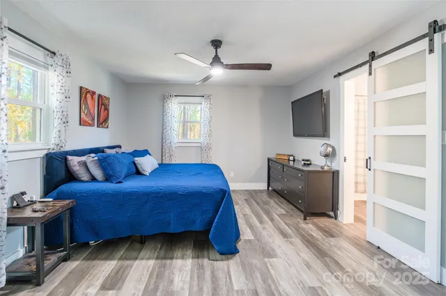 a bedroom with a bed and a flat screen tv