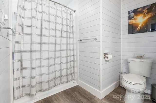 a bathroom with a toilet and a shower