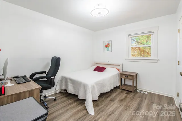 a bedroom with a bed and a desk