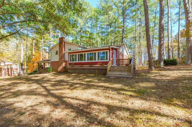 front view of a house with a large tree