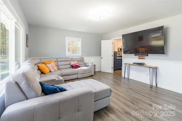 a living room with furniture and a flat screen tv