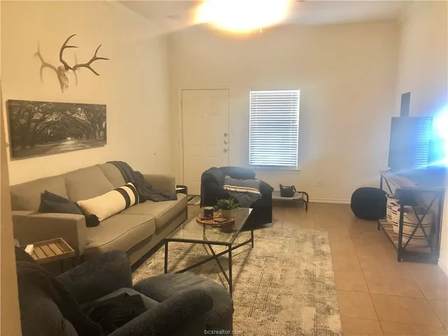a living room with furniture and a window
