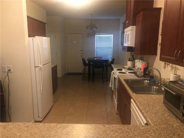 a kitchen with a sink stove and refrigerator