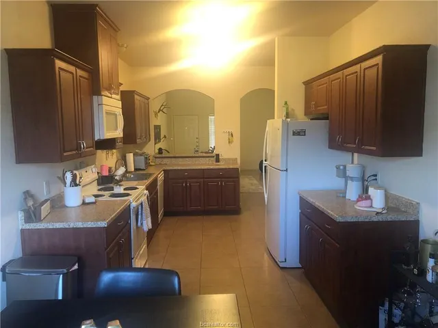 a kitchen with stainless steel appliances a sink stove and refrigerator
