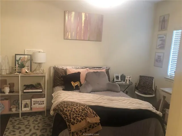 a bedroom with a bed and a television