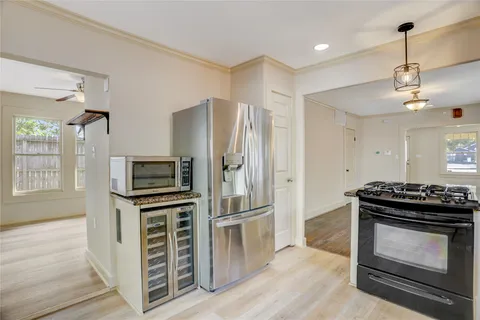 a kitchen with stainless steel appliances a stove a refrigerator and a refrigerator