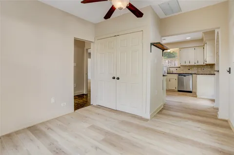 a view of a kitchen cabinets a sink and wooden floor