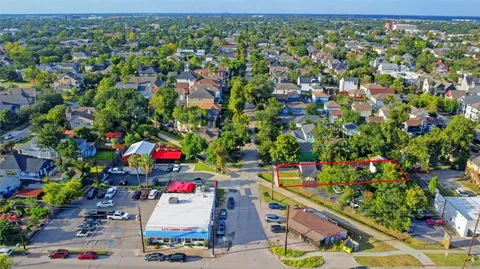 an aerial view of residential houses with outdoor space and street view