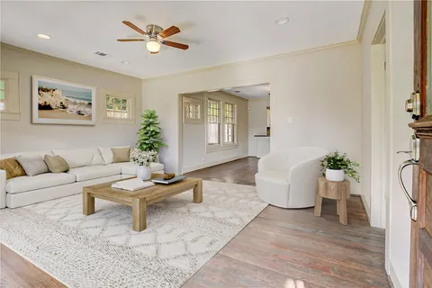 a living room with furniture and wooden floor