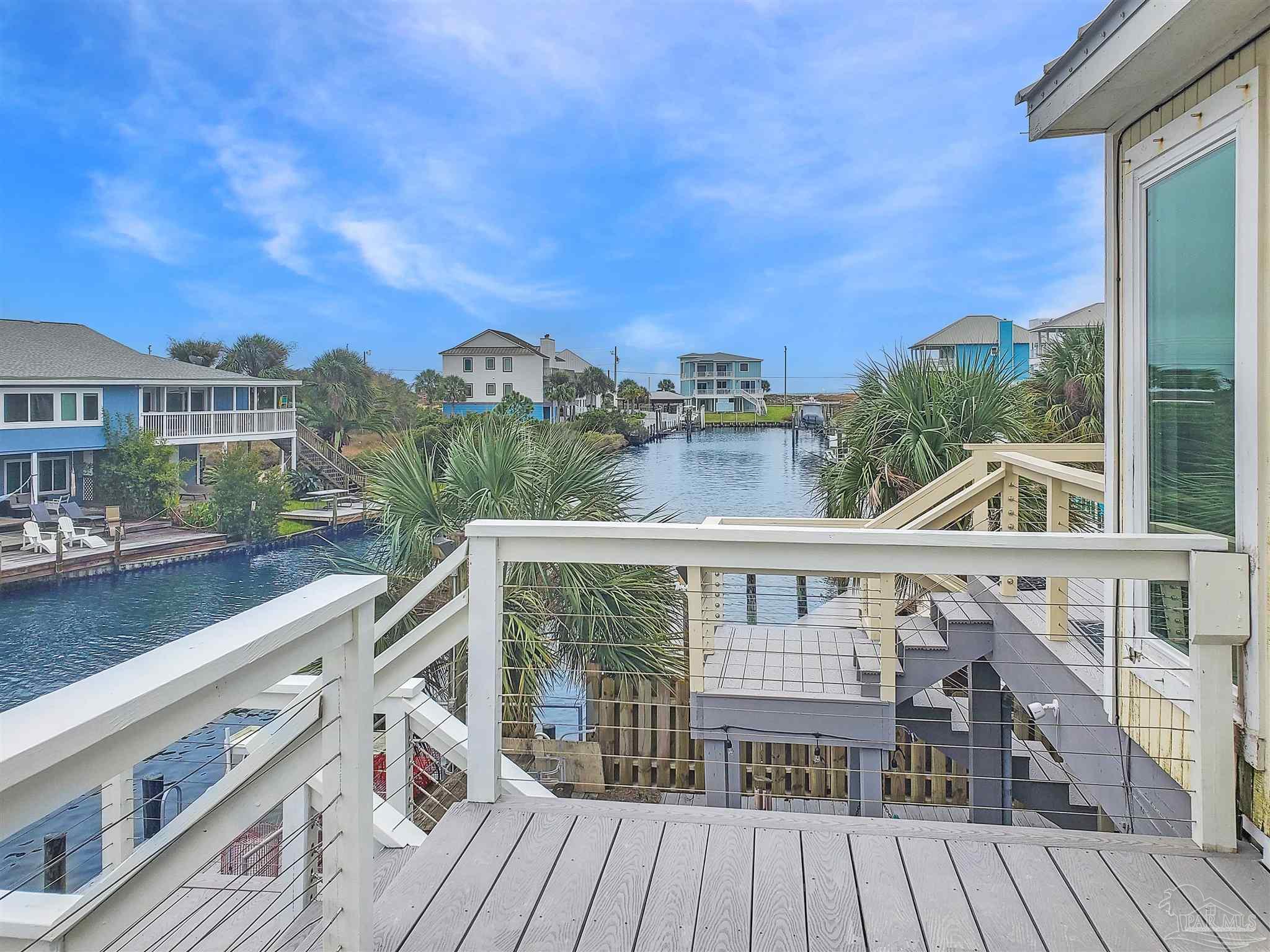7200 Sharp Reef, Unit 2 Pensacola, FL 32507 - Photo 1 of 24 a view of balcony with furniture and wooden floor