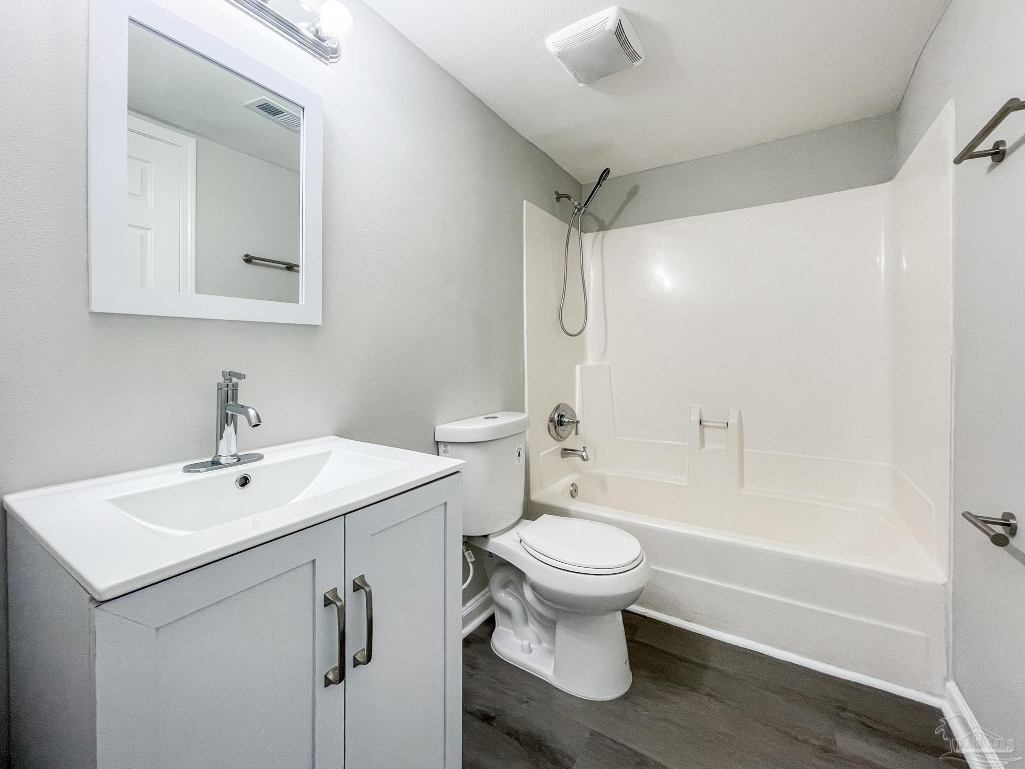 7200 Sharp Reef, Unit 2 Pensacola, FL 32507 - Photo 16 of 24 a bathroom with a sink toilet a mirror and shower