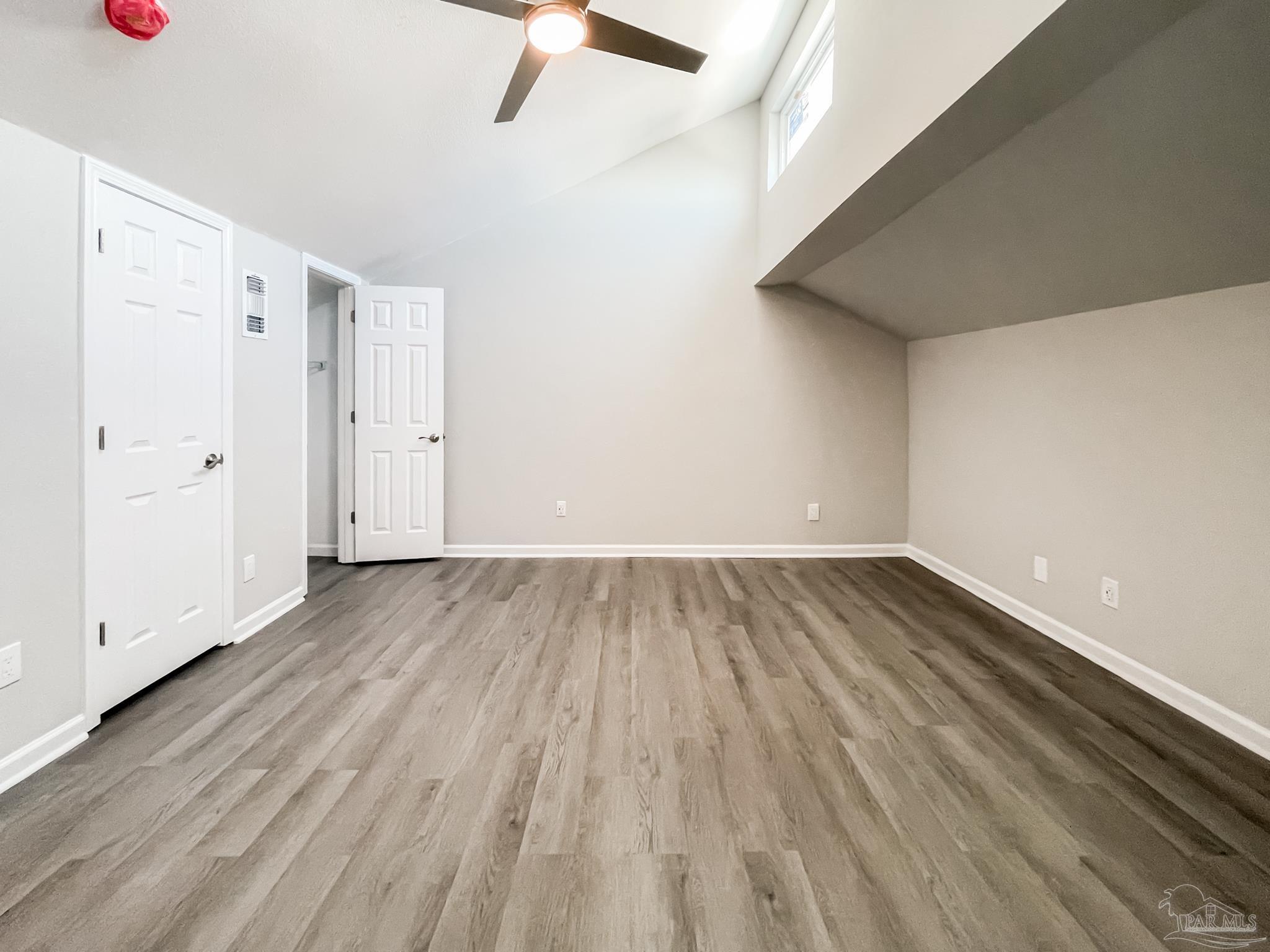 7200 Sharp Reef, Unit 2 Pensacola, FL 32507 - Photo 17 of 24 a view of an empty room with wooden floor