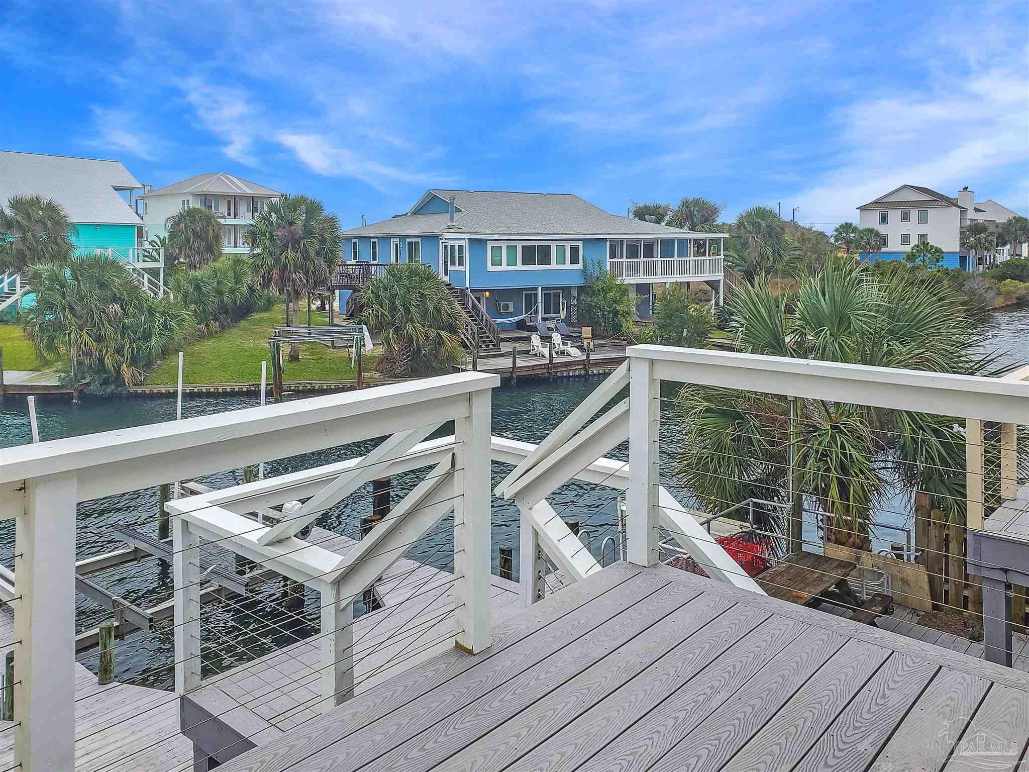 7200 Sharp Reef, Unit 2 Pensacola, FL 32507 - Photo 2 of 24 a view of a roof deck with two couches and wooden floor