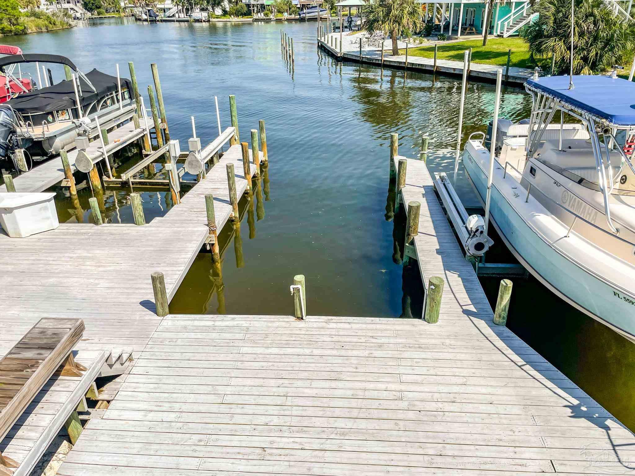 7200 Sharp Reef, Unit 2 Pensacola, FL 32507 - Photo 23 of 24 a view of a lake with a deck