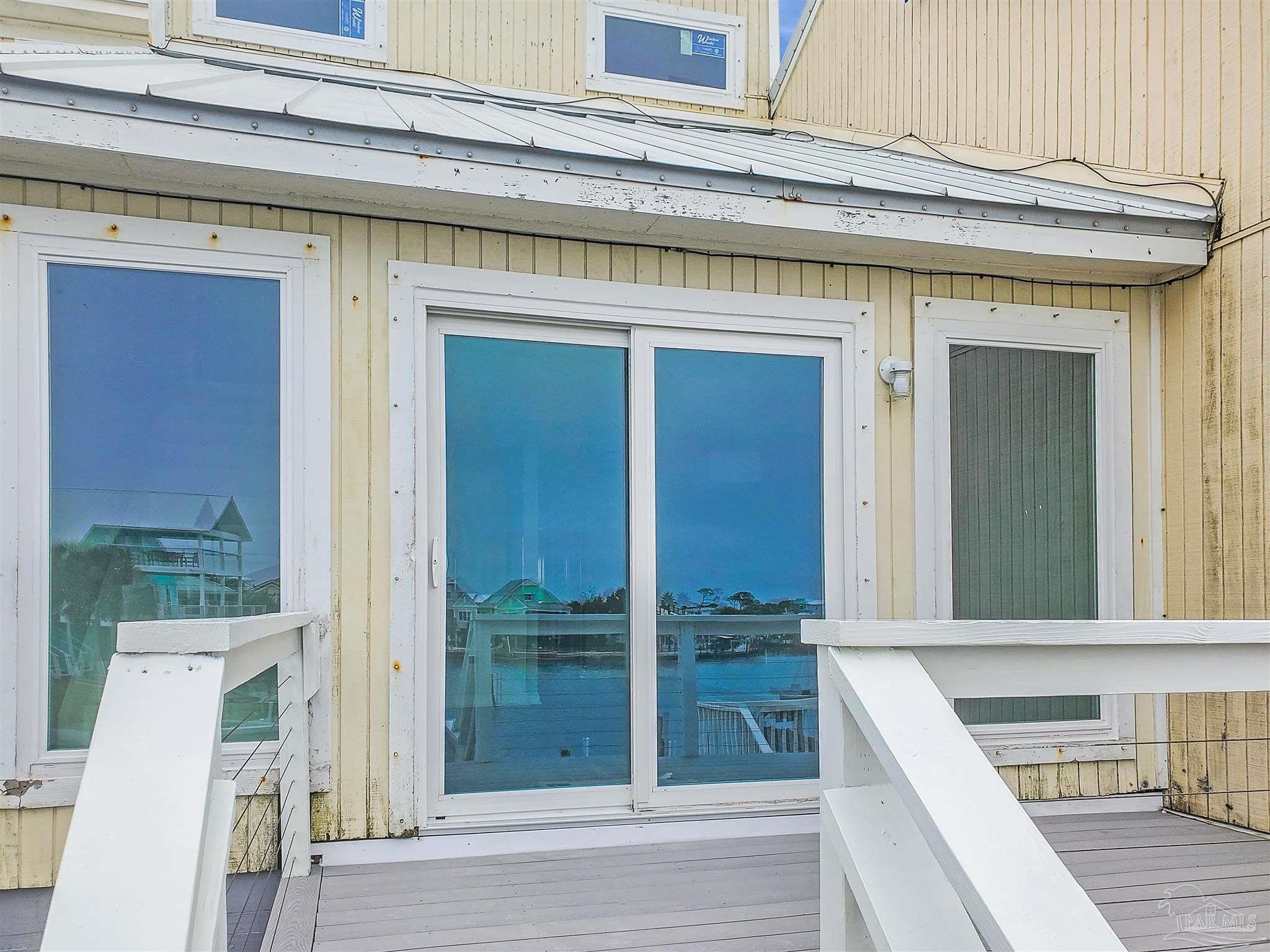 7200 Sharp Reef, Unit 2 Pensacola, FL 32507 - Photo 4 of 24 front view of a house with a porch