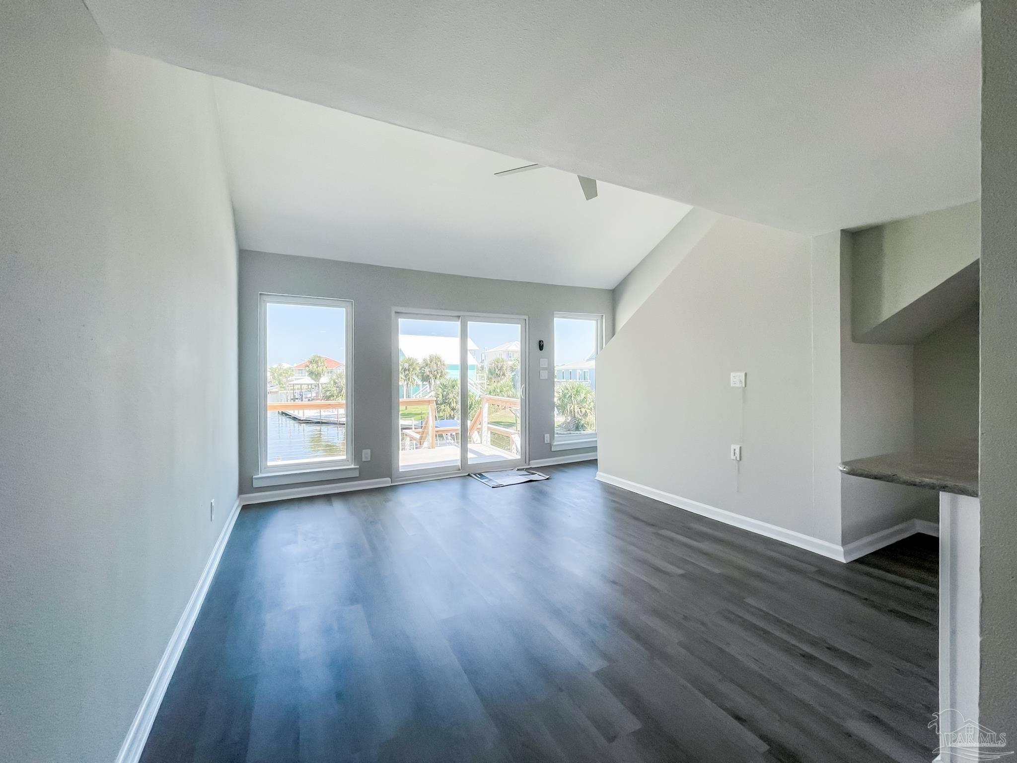 7200 Sharp Reef, Unit 2 Pensacola, FL 32507 - Photo 7 of 24 an empty room with wooden floor and windows