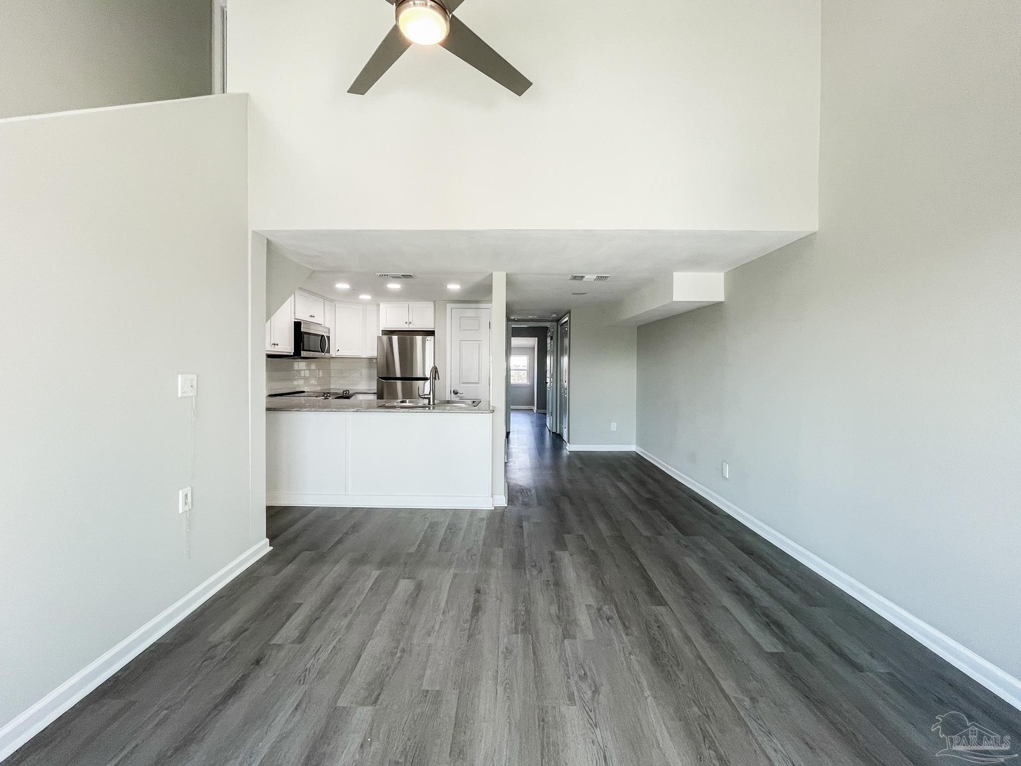 7200 Sharp Reef, Unit 2 Pensacola, FL 32507 - Photo 8 of 24 a view of a kitchen with wooden floor