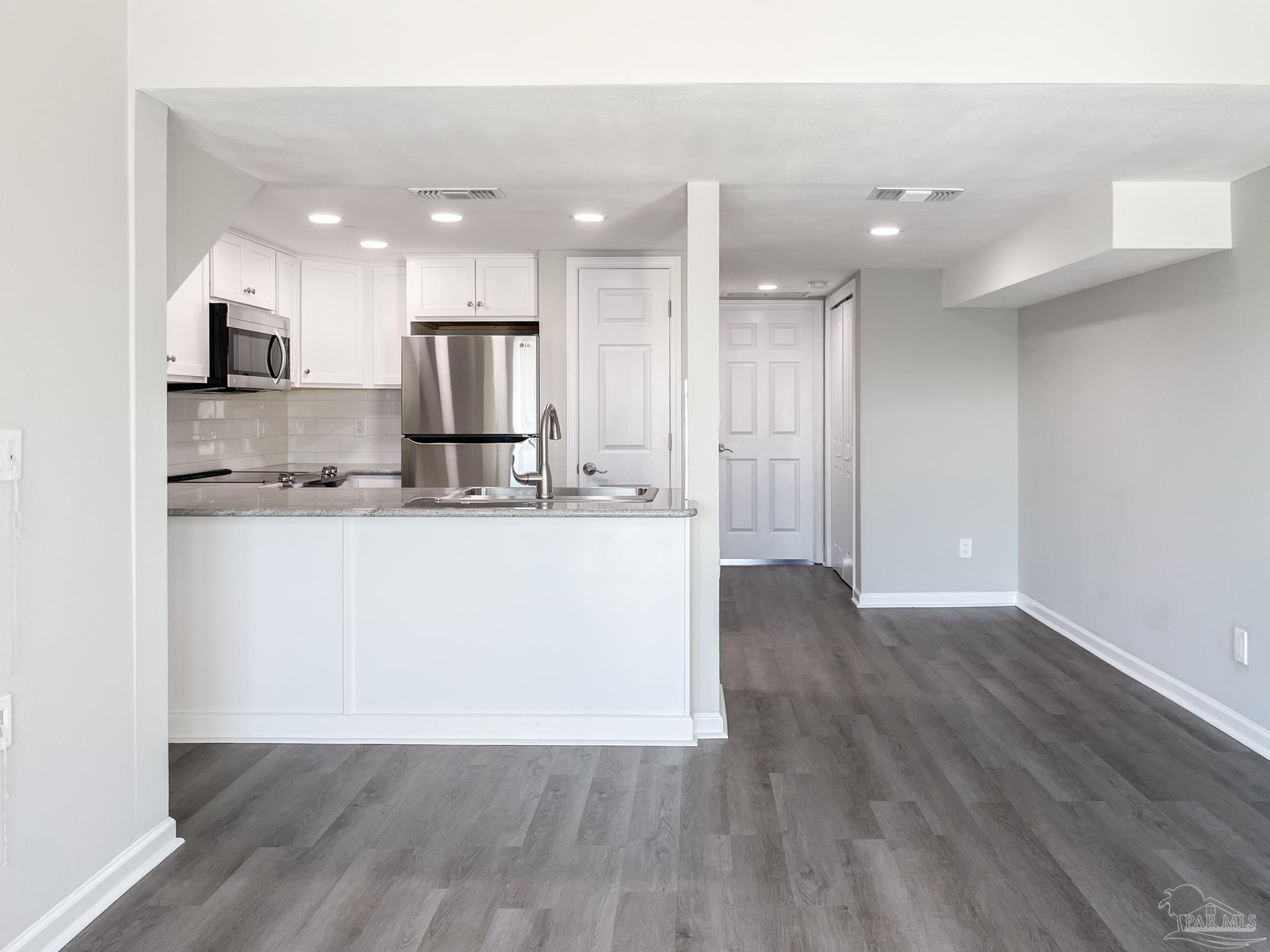 7200 Sharp Reef, Unit 2 Pensacola, FL 32507 - Photo 9 of 24 a view of kitchen with kitchen island and stainless steel appliances