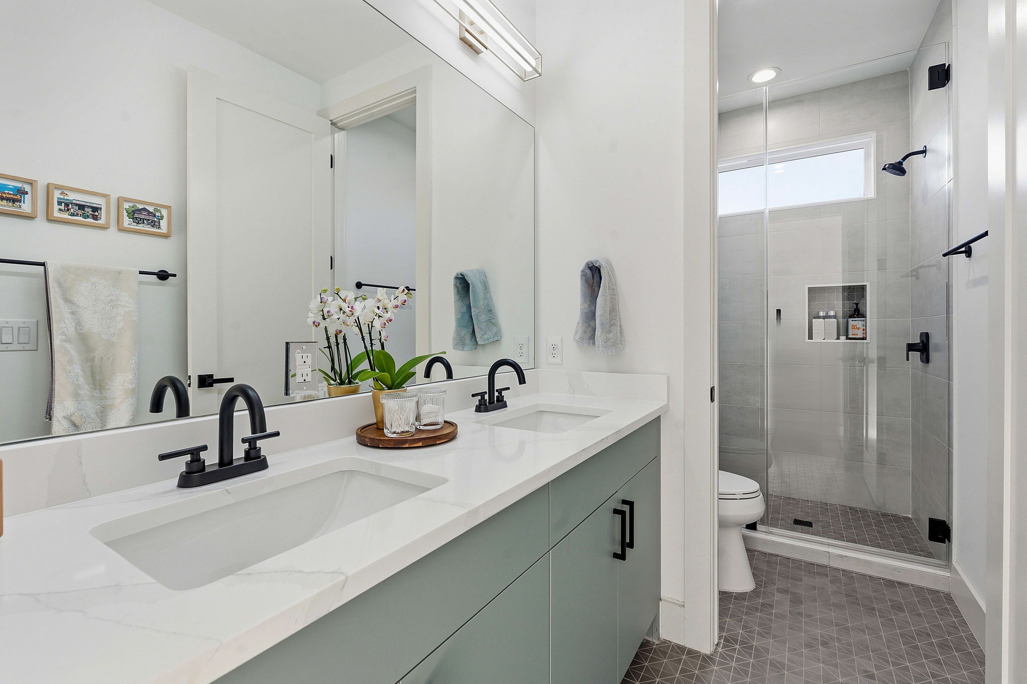 4313 Jinx Avenue, Unit 1 Austin, TX 78704 - Photo 15 of 40 Bathroom featuring double vanity, a stall shower, and light tile patterned floors