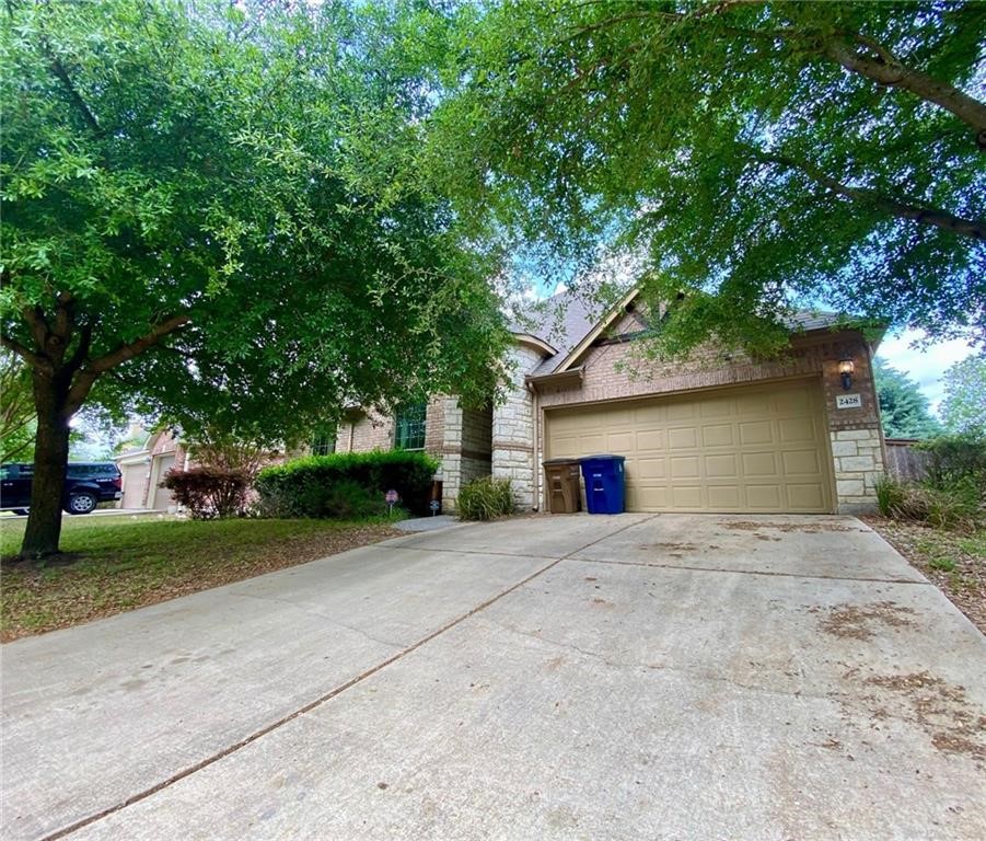 2428 Turtle Mountain Bend Austin, TX 78748 - Photo 1 of 1 a front view of a house with a yard and a garage