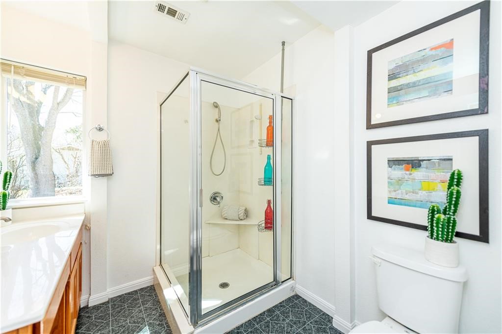 7305 Forest Wood Road Austin, TX 78745 - Photo 12 of 25 a bathroom with a shower and a sink