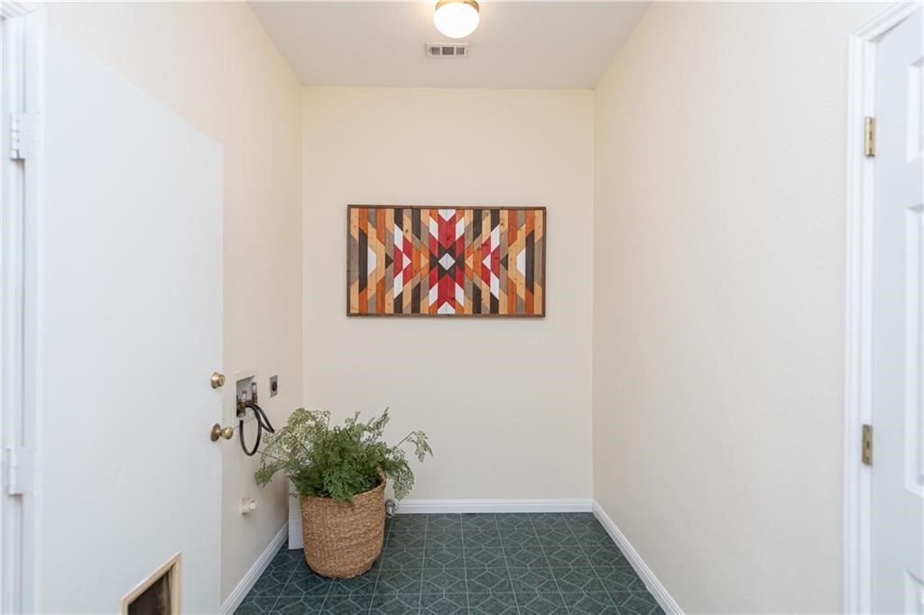 7305 Forest Wood Road Austin, TX 78745 - Photo 17 of 25 a room with a potted plant