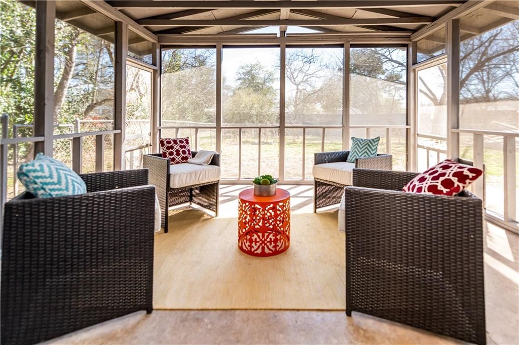 7305 Forest Wood Road Austin, TX 78745 - Photo 18 of 25 a living room with furniture and floor to ceiling windows