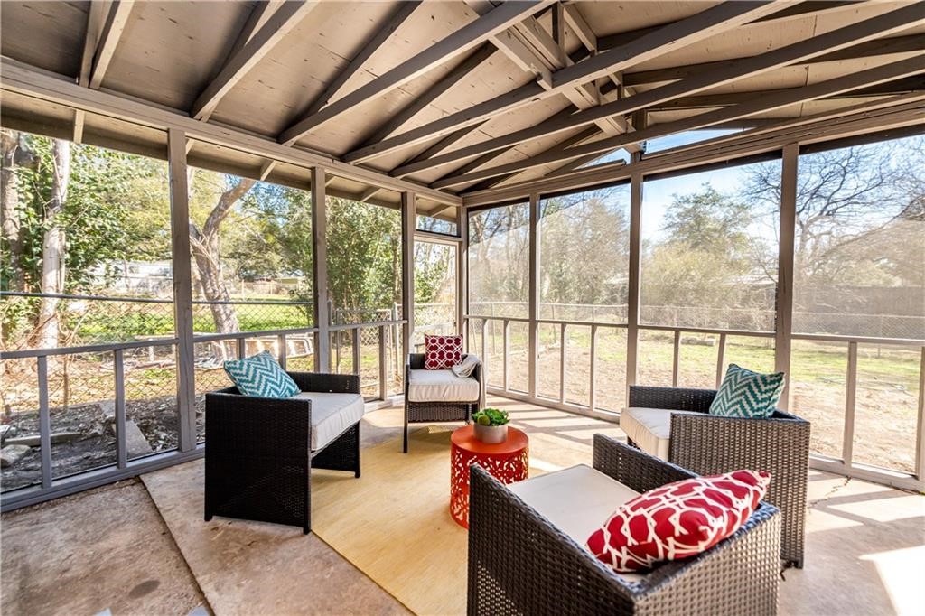 7305 Forest Wood Road Austin, TX 78745 - Photo 19 of 25 a living room with furniture and a floor to ceiling window