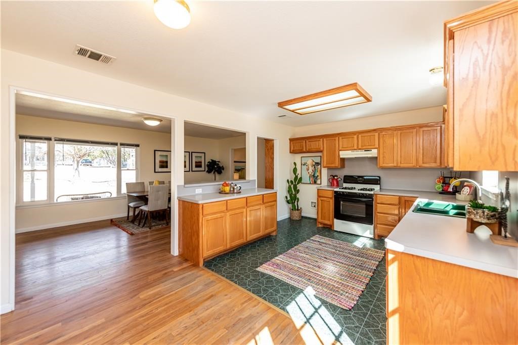 7305 Forest Wood Road Austin, TX 78745 - Photo 5 of 25 a kitchen with a sink appliances cabinets and a counter top space