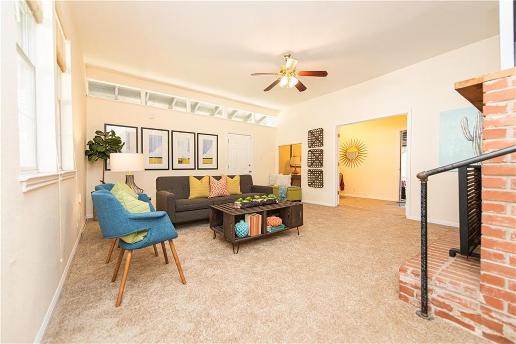 7305 Forest Wood Road Austin, TX 78745 - Photo 7 of 25 a living room with furniture and a table