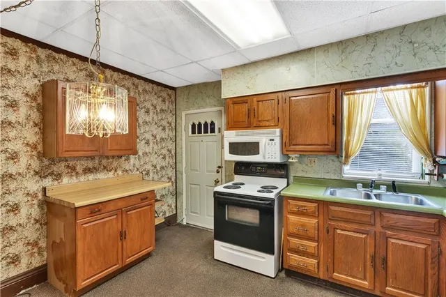 a kitchen that has a sink and a stove